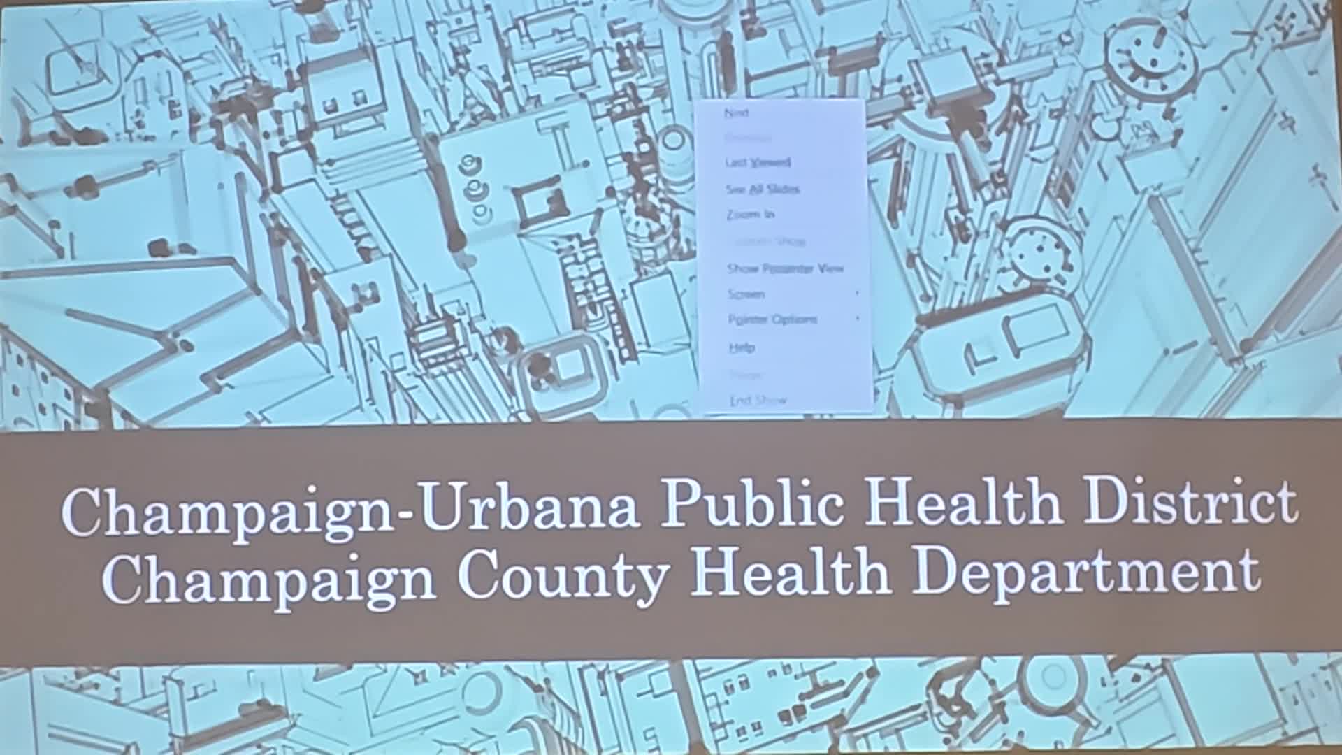 Slide with Champaign-Urbana Public Health District text on decorative background. 