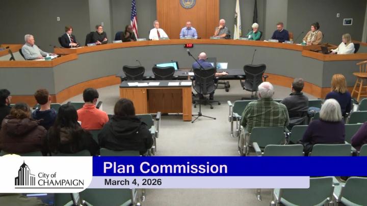 Wide shot of Dias with Plan Commissioners and a staff member at the presenter table. 