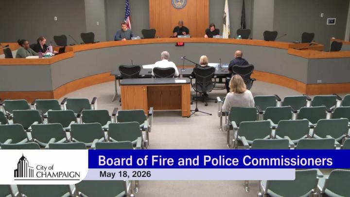 Wide shot of dais with three board members and three staff members sitting at table in front of them. 