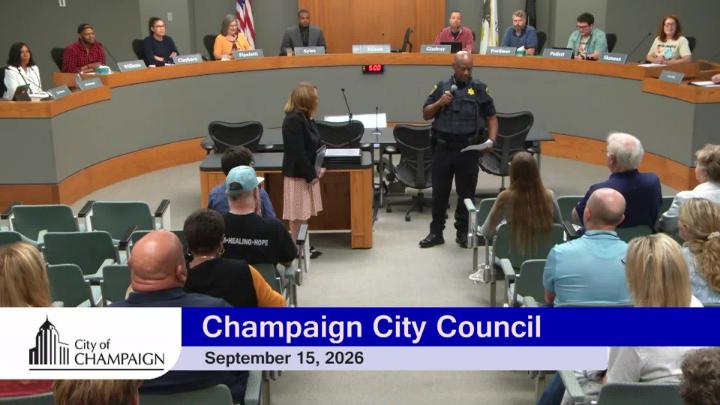 Mayor Feinen and Police Chief Timothy T. Tyler standing in front of audience getting ready to give new officers their police oaths. 